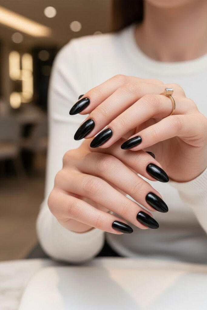 1. Classic glossy black almond nails
