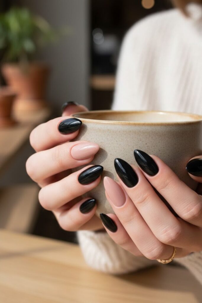 3. Black almond nails with nude accent