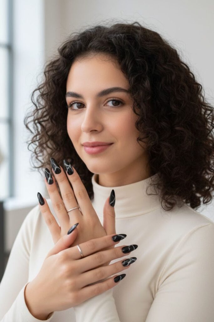 7. Black marble almond nails